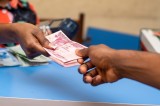 woman-giving-nigerian-naira-banknotes-to-a-man-2023-11-27-05-04-11-utc.jpg